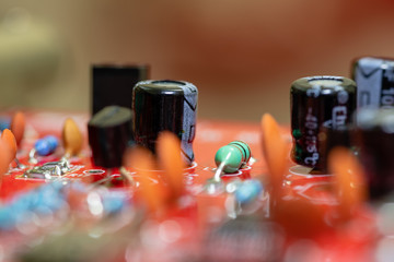 Close up (Macro) of Printed Circuit Board PCB embedded components (inductors, resistors, capacitors, diodes, microchips, transistor) with short depth of view