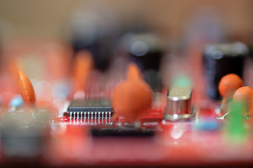 Close up (Macro) of Printed Circuit Board PCB embedded components (inductors, resistors, capacitors, diodes, microchips, transistor) with short depth of view