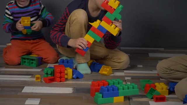 Child color cubes in abstract style on gray background. Colorful paint. Colorful blocks. Education, school. Play cubes. Children paint. Abstract background. Child development. Copy space.