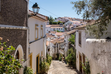 View down a narrow cobblestone street in the Jewish district of Castelo de Vide, Alentejo, Portugal