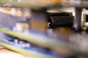 Close up (Macro) of Printed Circuit Board PCB embedded components (inductors, resistors, capacitors, diodes, microchips, transistor) with short depth of view.