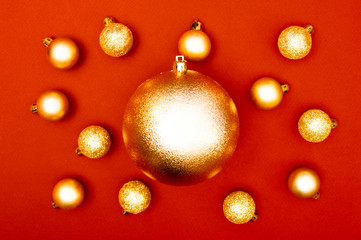 Multiple Christmas baubles creative decoration pattern on the red background. Concept.