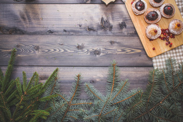 Happy New Year fir branches decorated with gingerbread stars, cinnamon sticks, dried orange slices...