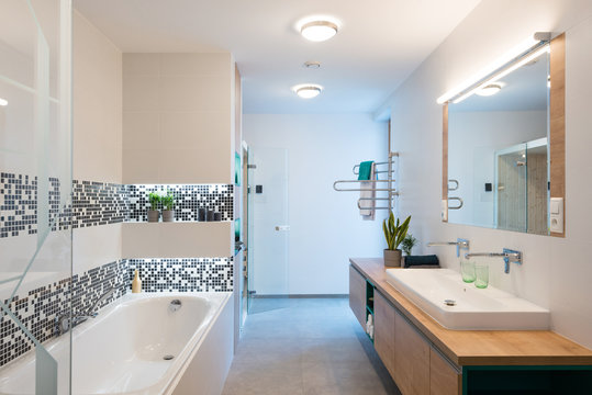 Interior of modern bathroom with bathtub and shower