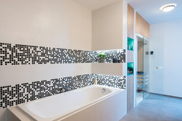 Small sauna cabin in bathroom of modern house