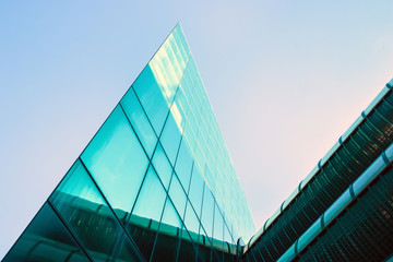 modern building triangular shape. Futuristic office on a clear sky background