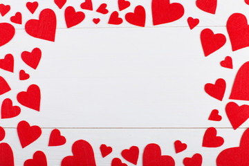 Red hearts of different sizes on a white background. Harvesting cards for Valentine's Day. Place for text, copy space.