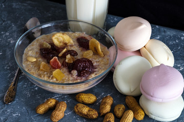 oatmeal with marshmallows and dried fruits in a dark key