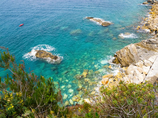 Elevated Cinque Terre National Park Mediterranean Sea coastline view with a boat in the distance, Cinque Terre, Liguria Italy