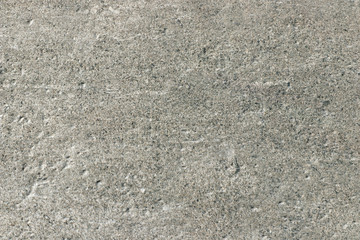 Texture of light gray stone with a rough and matte surface. Grunge background with space for text or image. Empty template and mockup for designers.