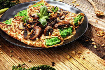 Savory Homemade Mushroom and Spinach Crepes with Cheese and avocado.