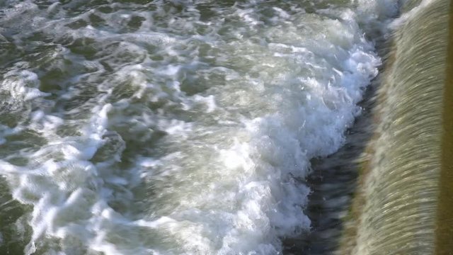 Artificial threshold height difference on the city river of green color