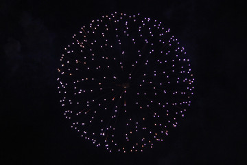 Blue firework exploding in black sky