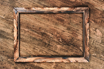 brown wood carved frame on wooden background. copy space