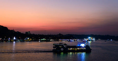 Sunset over the river in Panaji in Goa, India. Cityscape with boats.
