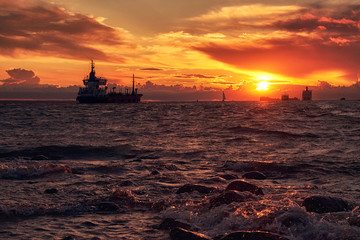 Sea sunset with ship ferry and boat on horizon