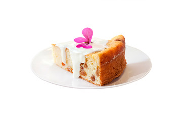 Sweet cottage cheese pudding with raisins and sour cream on a plate isolated on white background with clipping path