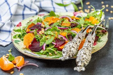 Organic arugula salad, tangerine and baked beetroot.