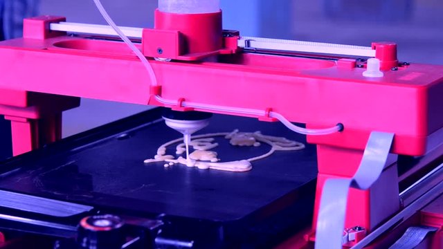 3d printer for liquid dough. 3D printer printing pancakes with liquid dough different shapes close-up. Modern additive technologies 4.0 industrial revolution. Red blue white colors.