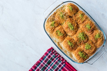Homemade Turkish Dessert Fincan Kadayif Baklava / Baklawa with Pistachio Powder.