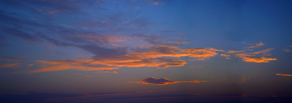 Beautiful sky with clouds at sunset with airliner