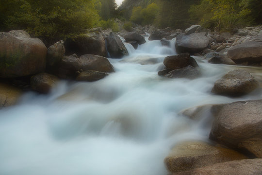Mountain river cascading on the stones, long exposition, soft filter