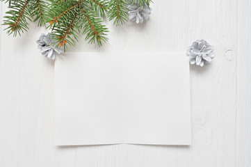 Empty white sheet of paper on a white Christmas background of fir branches and cones. Letter To Santa, mockup