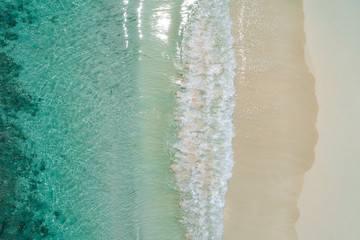 Beautiful tropical white empty beach and sea waves seen from above. Seychelles beach aerial view
