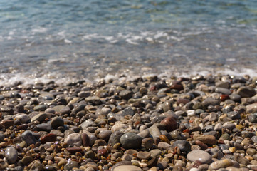 Colorful sea pebbles and clear water