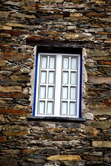 Rustic hand-hewn wood door set into a stone wall built from schist in Piod&atilde;o, made of shale rocks stack, one of Portugal's schist villages in the Aldeias do Xisto.