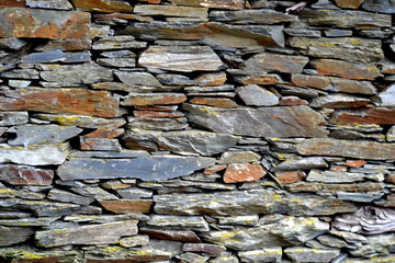 Close-up detail view of an old traditional stone wall built from schist in Piodão, made of shale rocks stack, one of Portugal's schist villages in the Aldeias do Xisto.
