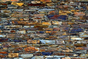 Close-up detail view of an old traditional stone wall built from schist in Piodão, made of shale rocks stack, one of Portugal's schist villages in the Aldeias do Xisto.