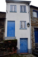 Rustic hand-hewn wood door set into a stone wall built from schist in Piodão, made of shale rocks stack, one of Portugal's schist villages in the Aldeias do Xisto.
