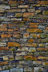 Close-up detail view of an old traditional stone wall built from schist in Piodão, made of shale rocks stack, one of Portugal's schist villages in the Aldeias do Xisto.