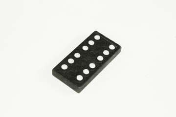 Single black domino stone on white background.
