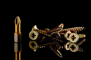 Obraz premium Screwdriver head, close-up bit, selective focus. blurred dark background