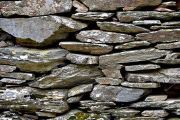 Close-up detail view of an old traditional stone wall built from schist in Piodão, made of shale rocks stack, one of Portugal's schist villages in the Aldeias do Xisto.