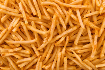 Background of stack of crispy french fries, directly above. Close up.
