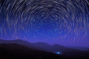 Beautiful Star Trails above high mountain at night, Tham Sakoen View Point attraction on route 1148...