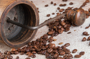 Old coffee grinder on concrete background.
