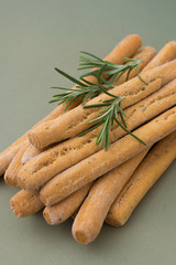 Grissini on grey table. Traditional italian snack with herbs. Copy space. Vertical image.