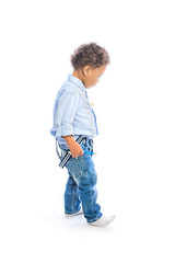 Happy dark skinned child with a pencil in his hands looks away on an isolated background