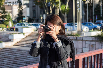 Chinese Girl Standing on the Bridge and Taking Picture With Her Photo Camera