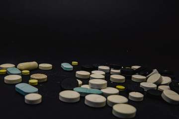 Obraz na płótnie Canvas Pile of several medicines on black background