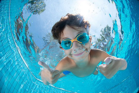 Underwater Young Boy Fun in the Swimming Pool with Goggles