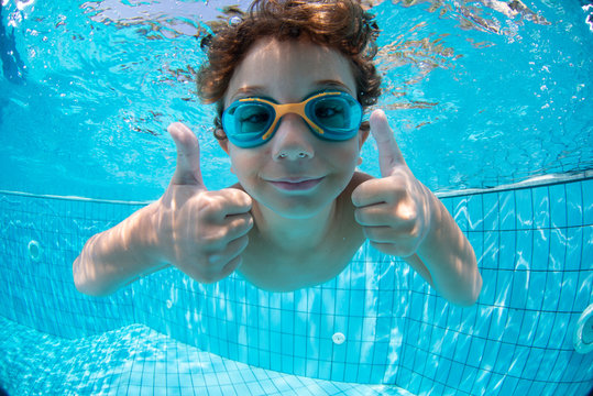 Underwater Young Boy Fun in the Swimming Pool with Goggles