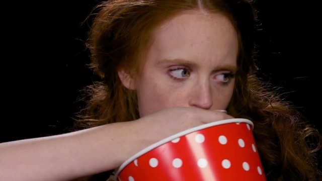 Bulimic woman eating popcorn