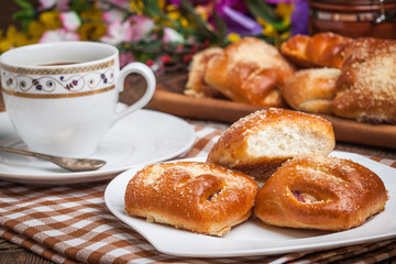 Buns with berries on a wooden table.