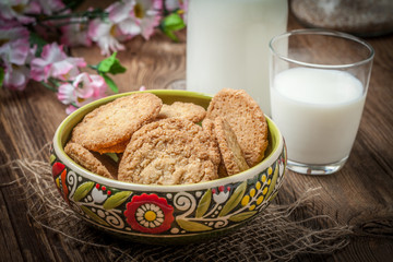 Stack of freshly baked oat biscuits in a bowl.