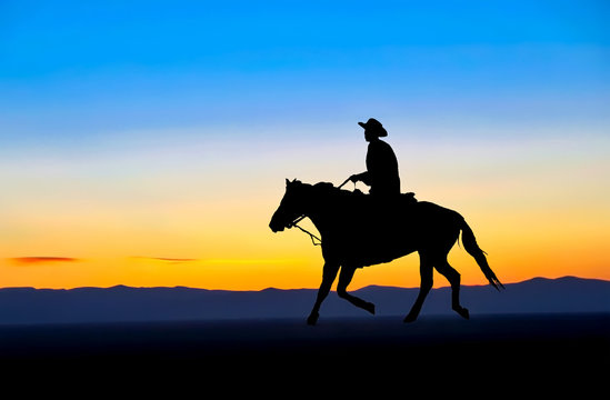 Cowboy on horseback silhouetted against the sunset.